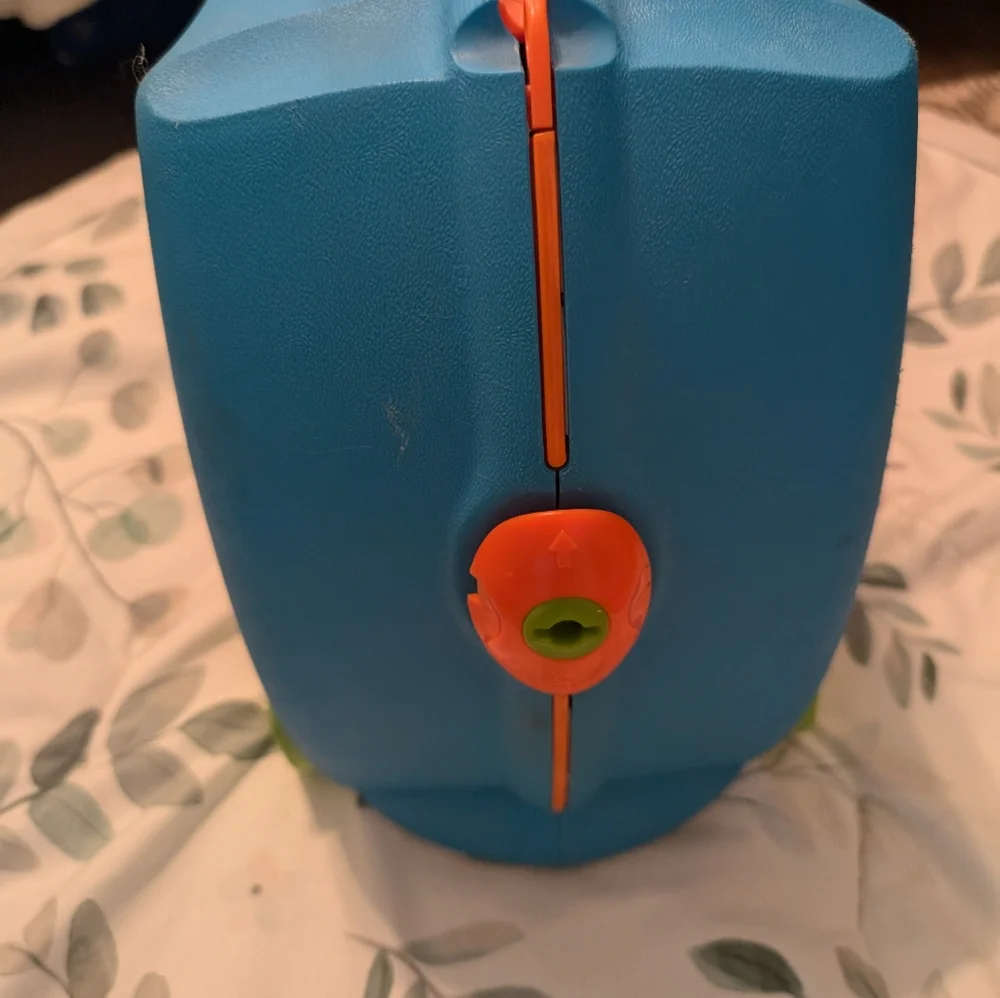 Melissa & Doug blue ride-on Trunki with green wheels and orange handle